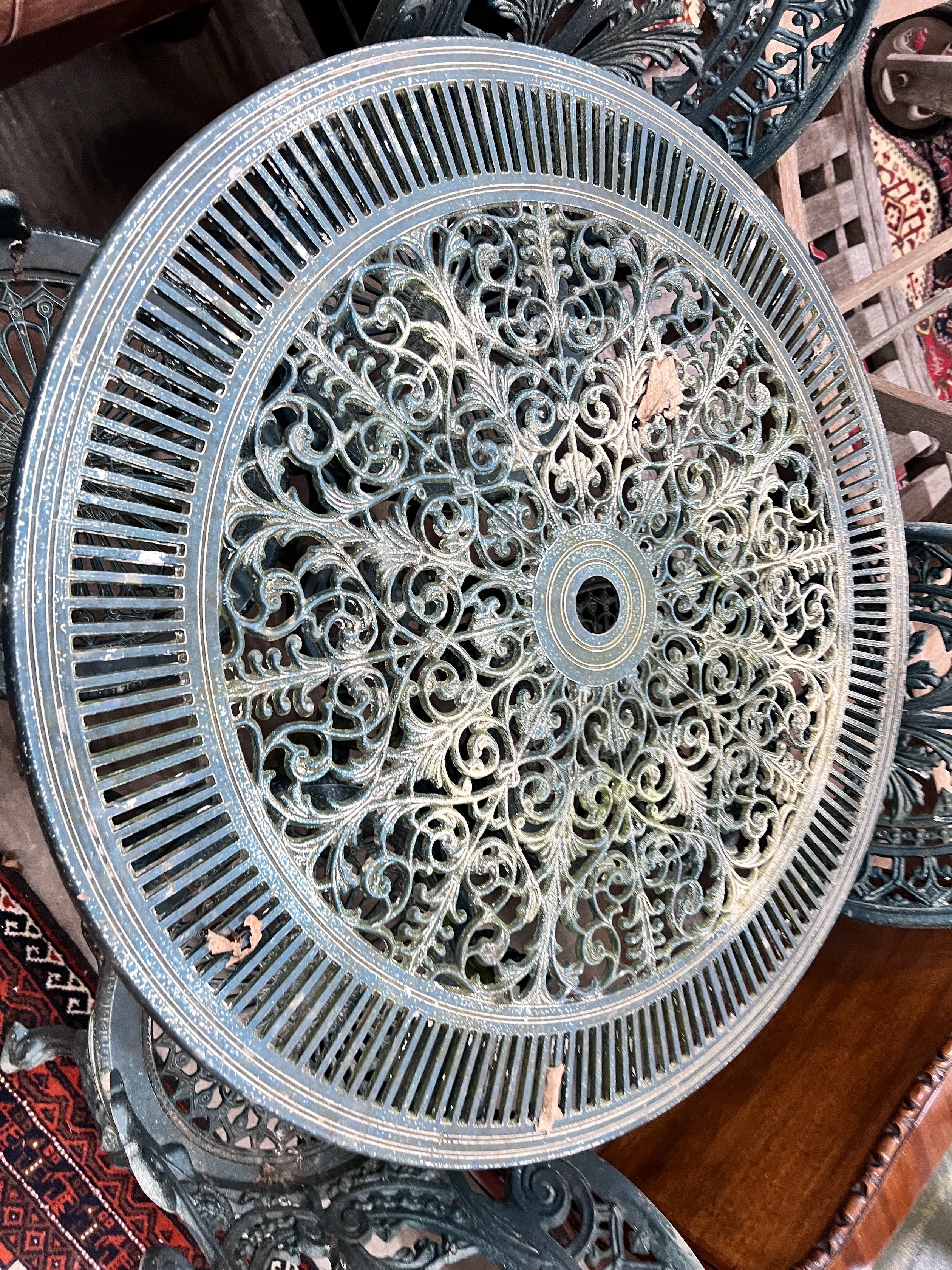 A Victorian style circular aluminium table, diameter 80cm, height 69cm and four matching chairs *Please note the sale commences at 9am.